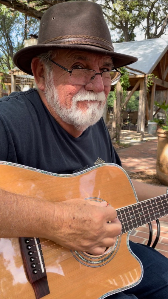 Close-up of Kokomo Joe playing guitar outdoors