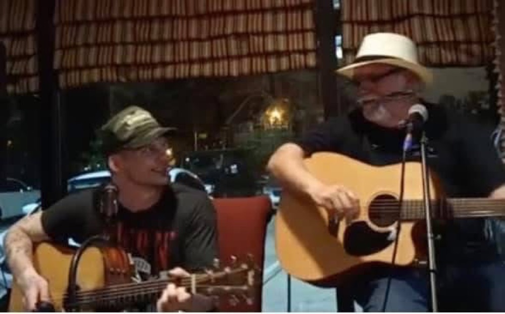 Kokomo Joe performing a duet at a restaurant window